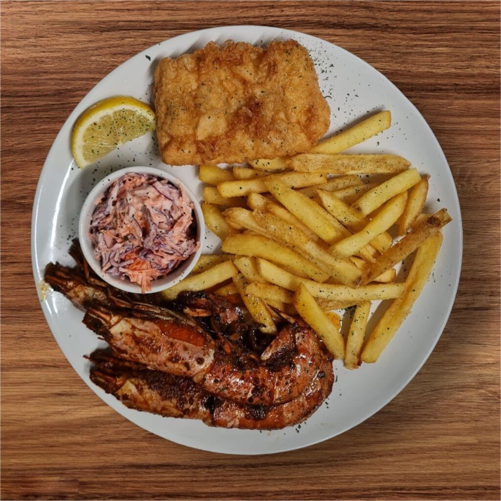 Fish combo: langoustine prawns, battered cod, chips and coleslaw
